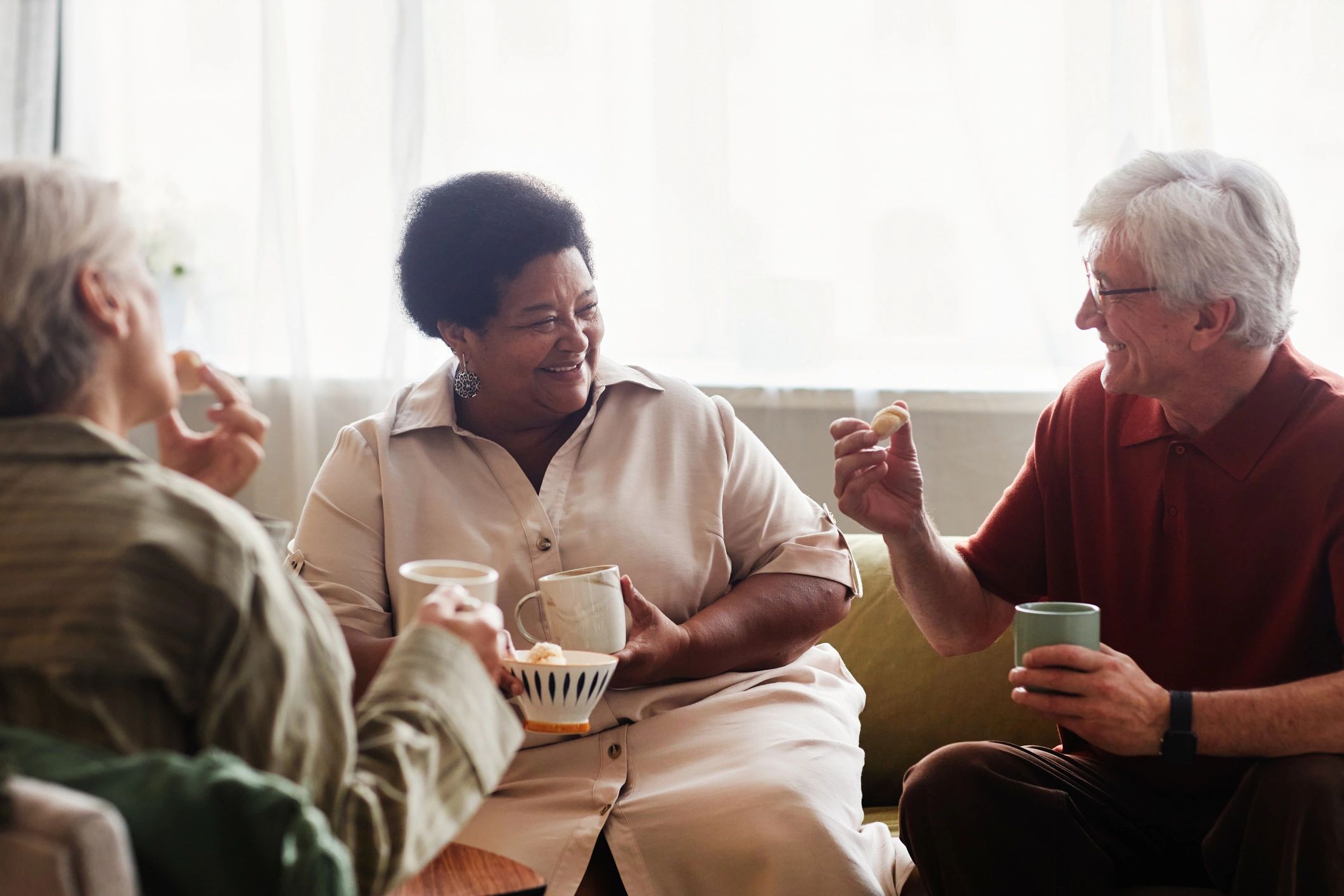 Older adults socializing over tea in a residential setting