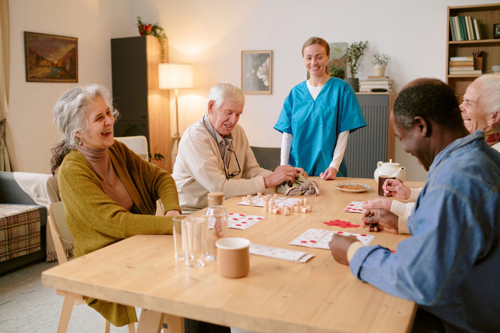 Nursing home residents with staff in a communal activity space