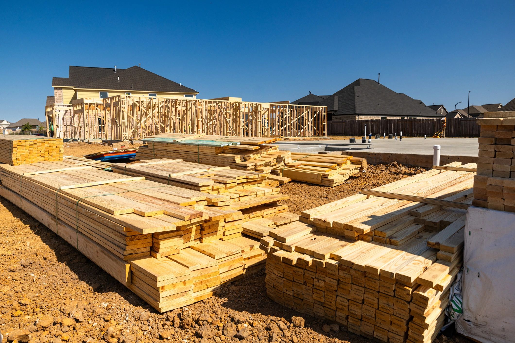 New development foundations and framing materials at a building site